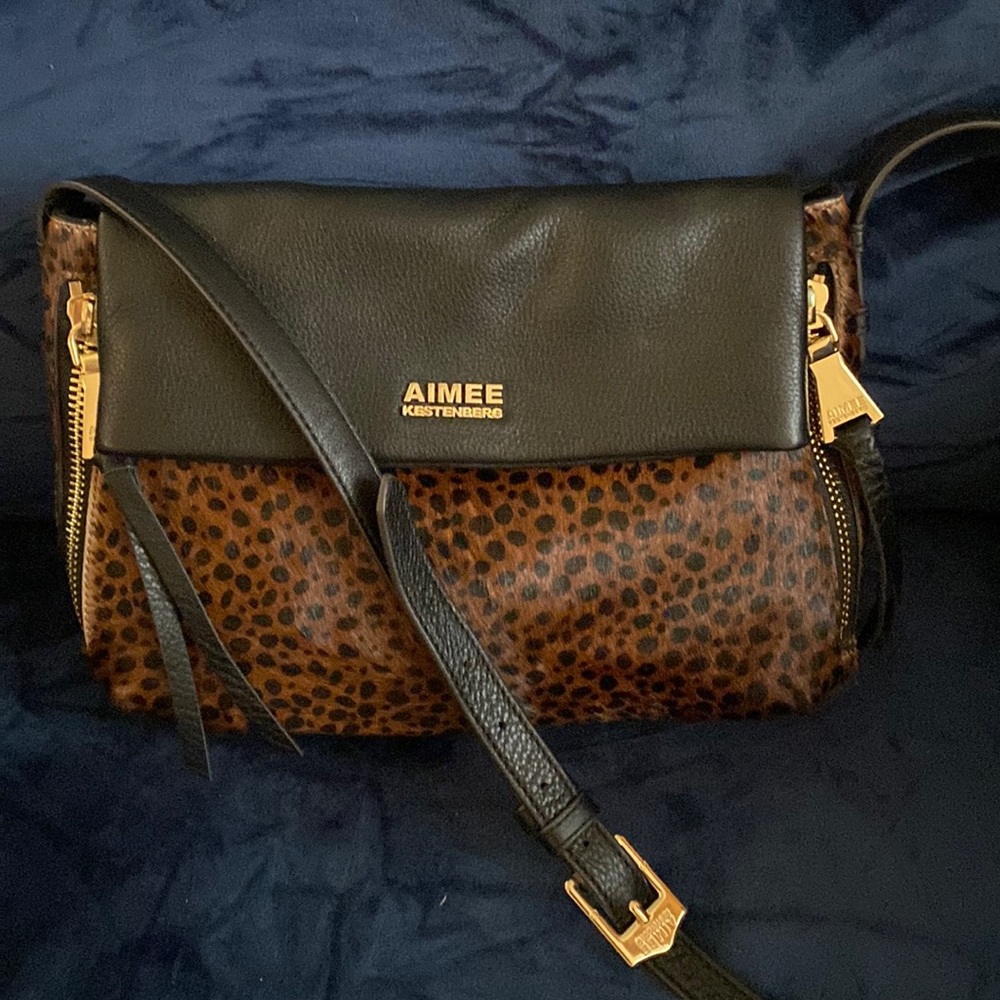 “Black leather Animal print in front is very soft. No scuffs or markings